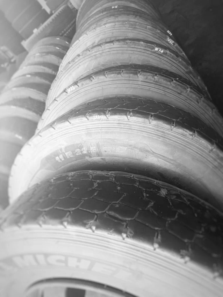 Truck tires removed during tire rotation service and measured for circumference matching before dual tire pairing