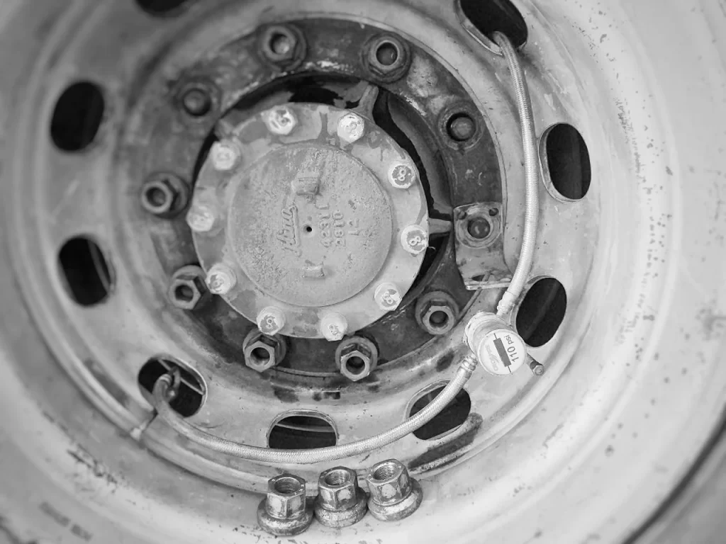 Truck dual tires matched by circumference and fitted with a tire pressure equalization system for improved tire rotation wear control