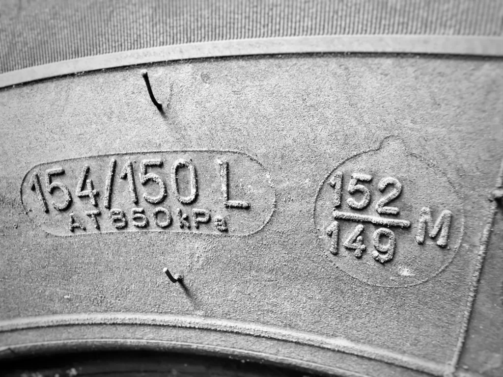 Truck tire sidewall showing unique dual load index markings of 154 150 L and 152 149 M.
