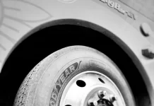 Grayscale closeup of a Goodyear truck tire and wheel assembly.
